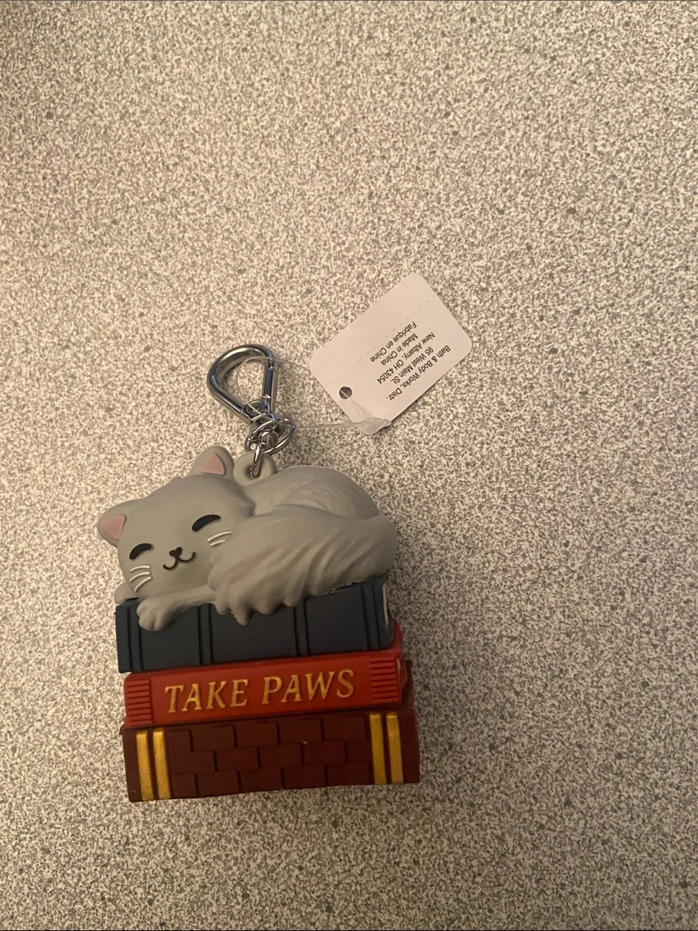 Cat on top of book hand sanitizer holder